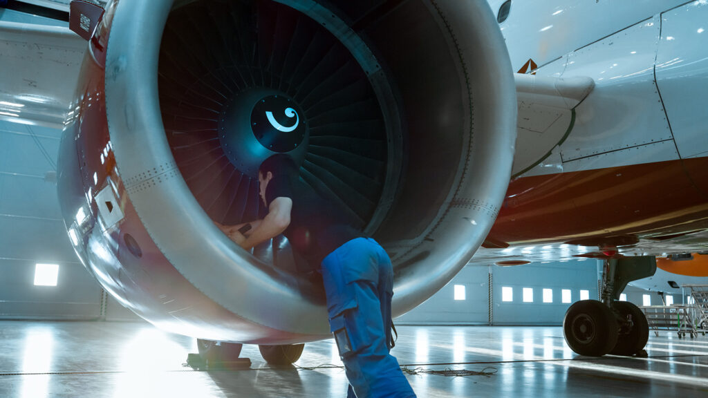 Man working on airplane engine