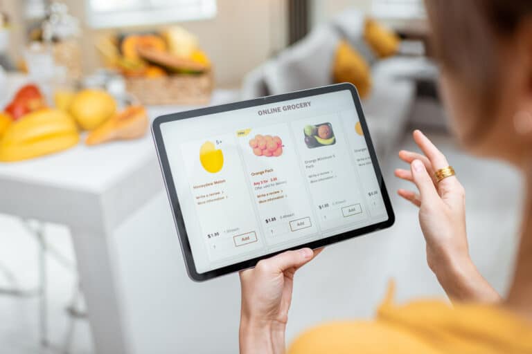 Woman shopping for groceries online using tablet computer