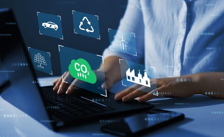 Person typing on laptop with floating decarbonisation icons
