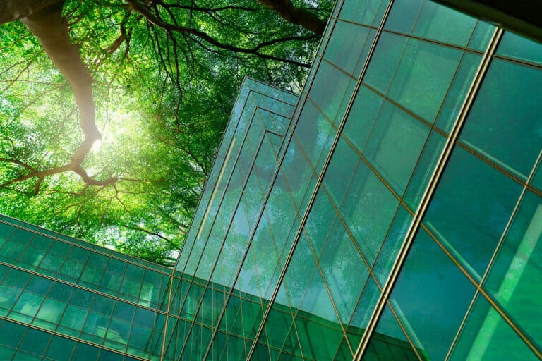 Glass building with trees from below