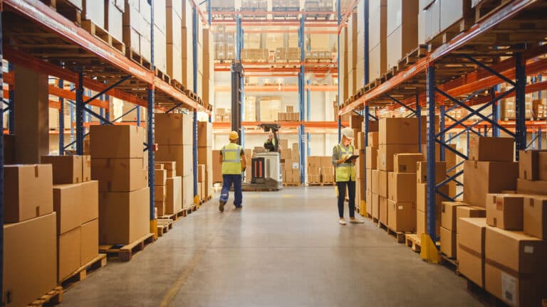 Retail Warehouse full of Shelves with Goods in Cardboard Boxes, Workers Scan and Sort Packages, Move Inventory with Pallet Trucks and Forklifts. Product Distribution Logistics Center.