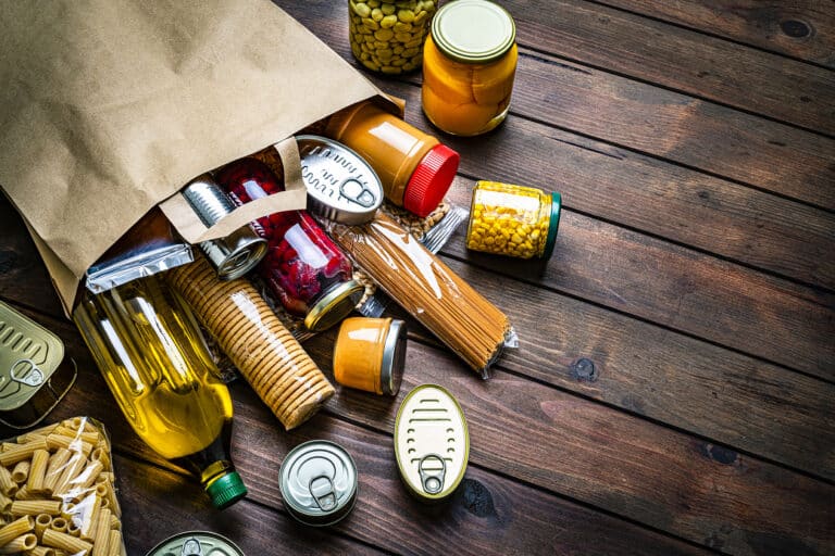 Non-perishable foods coming out a paper bag.