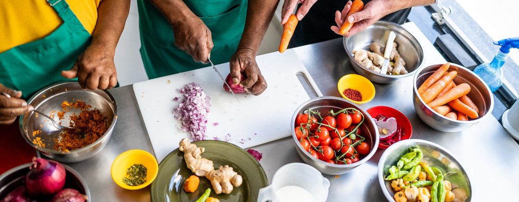 Hands cutting onion in the kitchen