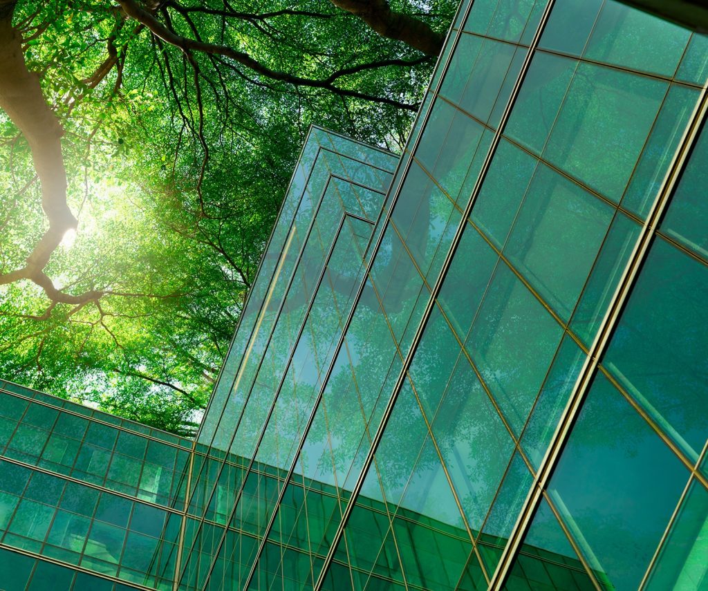 Glass building with trees from below