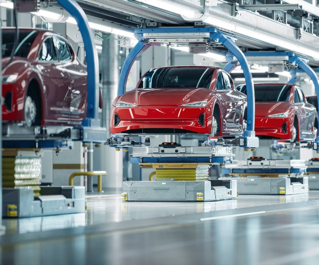 EV Production Line on Advanced Automated Smart Factory. High Performance Electric Car Manufacturing. Car Batteries Installation on Electric Vehicles on Assembly line